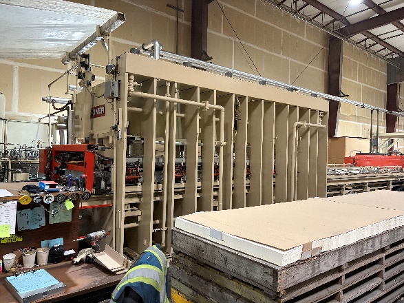 Laminate being permanently bonded to panels in the hot press