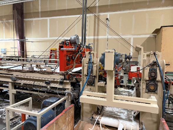 Panel edges being milled smooth to remove excess paper