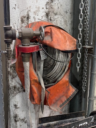 Fire hose station mounted on an interior wall