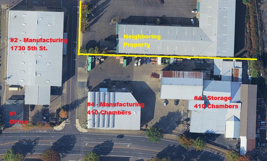 Annotated aerial photograph of the Specialty Laminates USA site showing building 1 office, building 2 manufacturing at 1730 5th Street, building 4 manufacturing at 410 Chambers, building 4 storage at 410 Chambers, and a neighboring property outlined in yellow